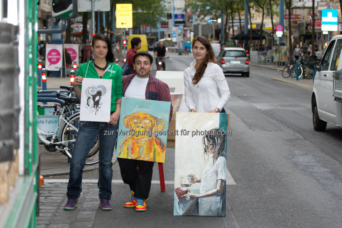 S Immo: Am 17.10.2013 öffnet der Wiener Kunstsupermarkt zum siebenten Mal in der Mariahilfer Straße 103, einem Gebäude der S Immo AG, seine Pforten. Unter dem Motto Kunst erschwinglich machen bietet der Kunstsupermarkt Originalkunstwerke zu günstigen Preisen. Im Bild die jungen Kunstschaffenden Johanna Kleedorfer und Antonio Semeraro mit Organisatorin Sophia Sladky (im weißen Hemd) in der Mariahilfer Straße (c) Gernot Singer für Kunstsupermarkt