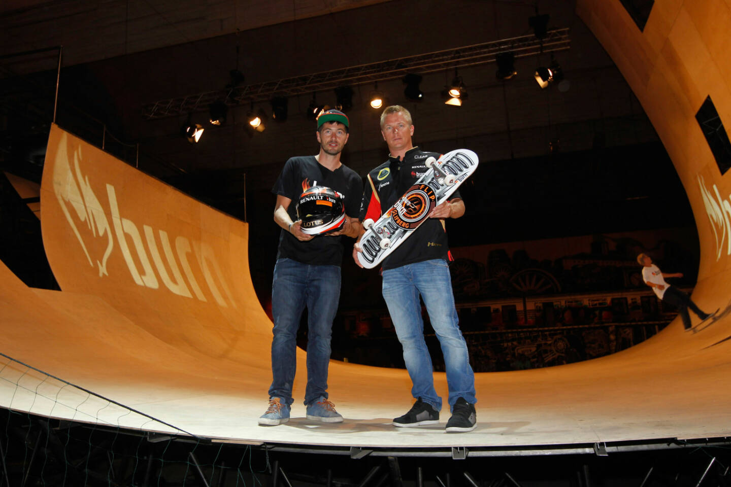  Lotus F1¨ Team driver Kimi Räikkönen exchanging his F1 helmet for a customised skateboard from champion skateboarder Rune Glifberg at burn Yard Live in Budapest, 26th July 2013