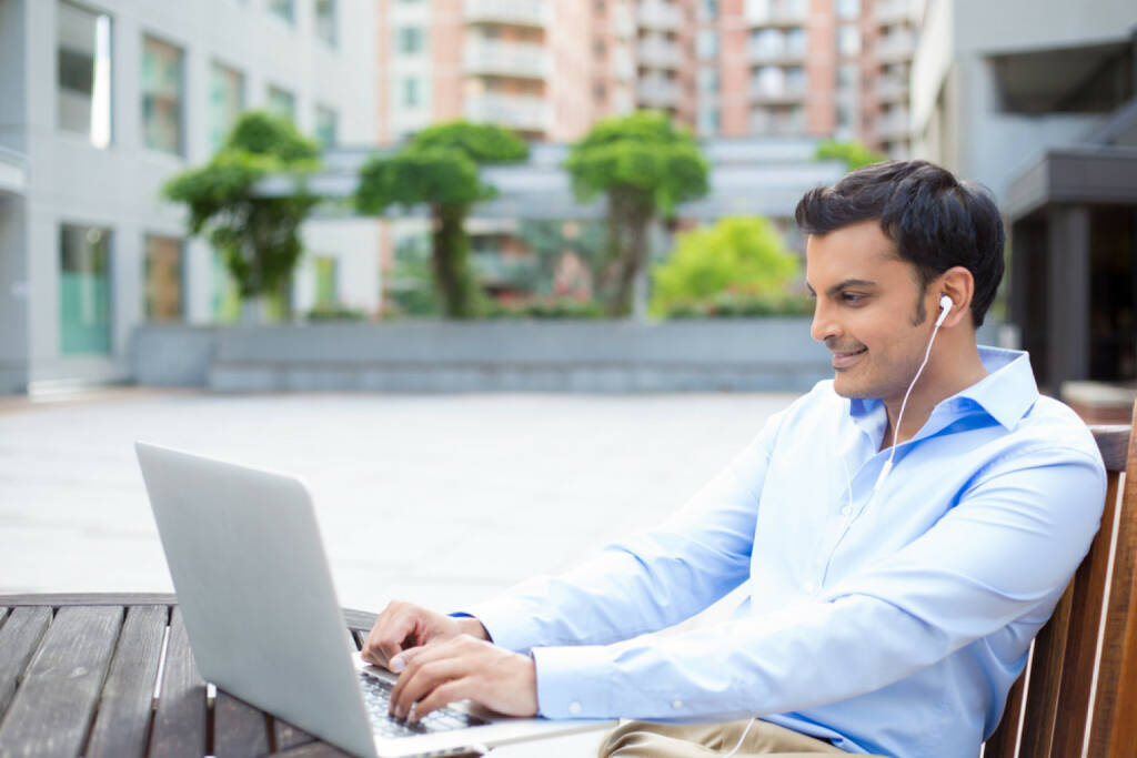 business, office, runplugged, Laptop, arbeiten, headphones, Kopfhörer, Musik, http://www.shutterstock.com/de/pic-198311093/stock-photo-closeup-portrait-young-handsome-man-in-blue-shirt-typing-away-listening-to-headphones-browsing.html  get the Runplugged App http://bit.ly/1lbuMA9 , © www.shutterstock.com (01.08.2014) 