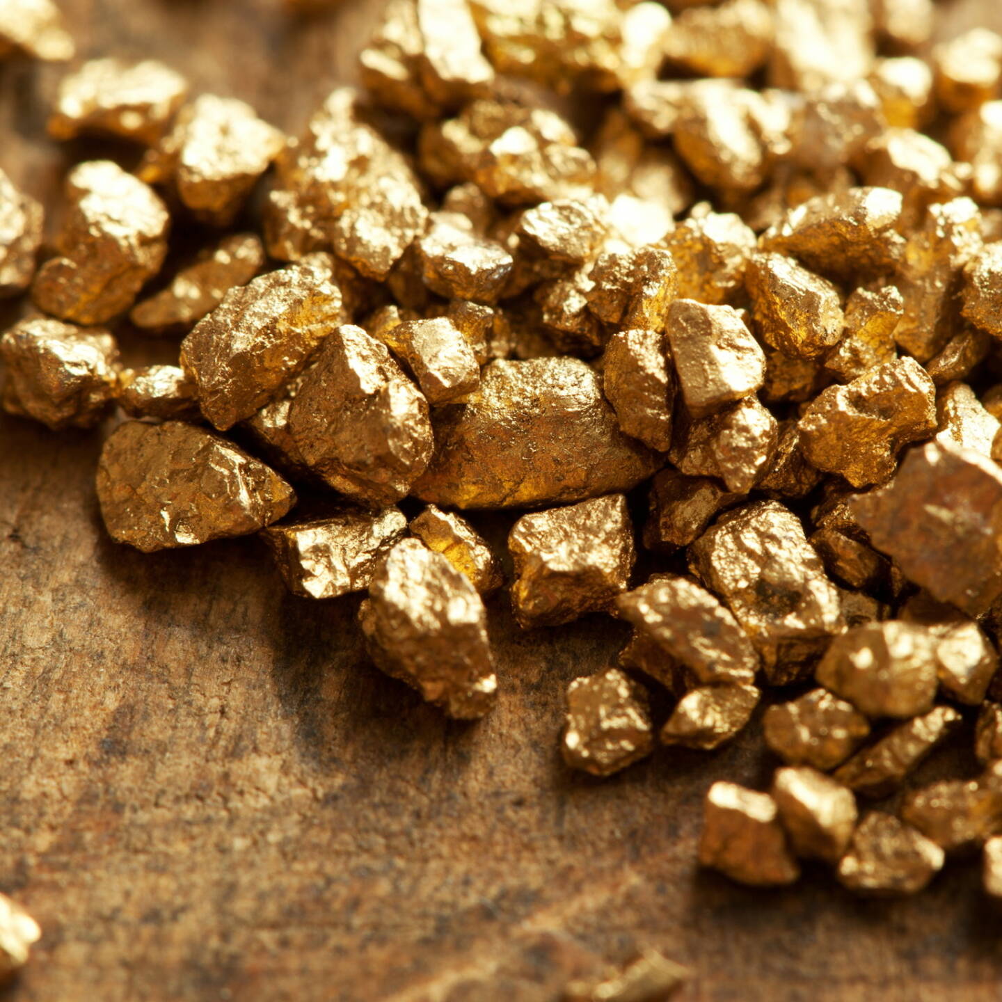 Gold, Nuggets http://www.shutterstock.com/de/pic-115609993/stock-photo-a-mound-of-gold-on-a-old-wooden-work-table.html